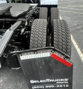Freightliner Cascadia 126 rear view showing dual rear axles and mud flaps with SelectTrucks Atlanta branding.