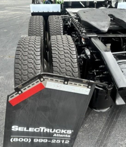 Freightliner Cascadia 126 truck rear wheels and fifth wheel area with SelectTrucks Atlanta plate and contact number.