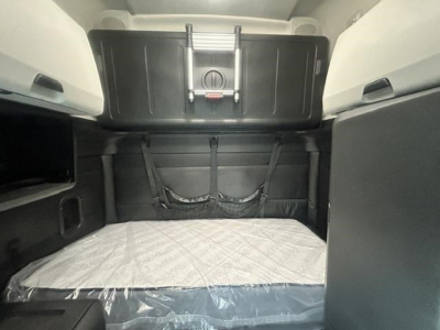 Freightliner Cascadia 126 sleeper cab interior cargo area with bunk bed mattress visible and storage compartments