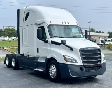 Freightliner Cascadia 126 conventional sleeper truck in view showing sidelined cab and dual rear axles.