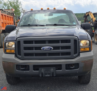 Ford F-350 front view service body truck with lift crane, black grille, gray bumper, amber cab lights, and large side mirrors.