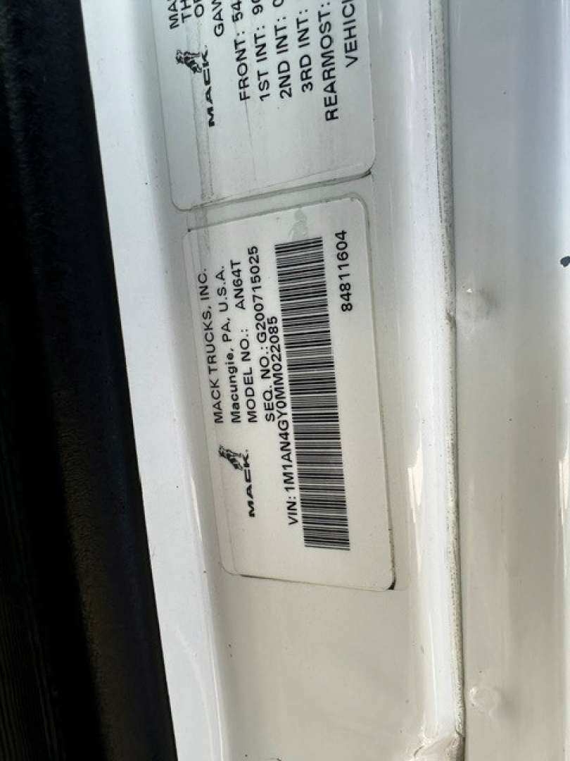 Mack label on door jamb with VIN and model details visible. Text includes MACK TRUCKS INC., MODEL NO., MODEL 2077, VIN 1M1AN4GY0MM022085, SERIAL 8A9T1604, REAR AXLE, BODY TYPE, MACK TRUCKS INC.  USA