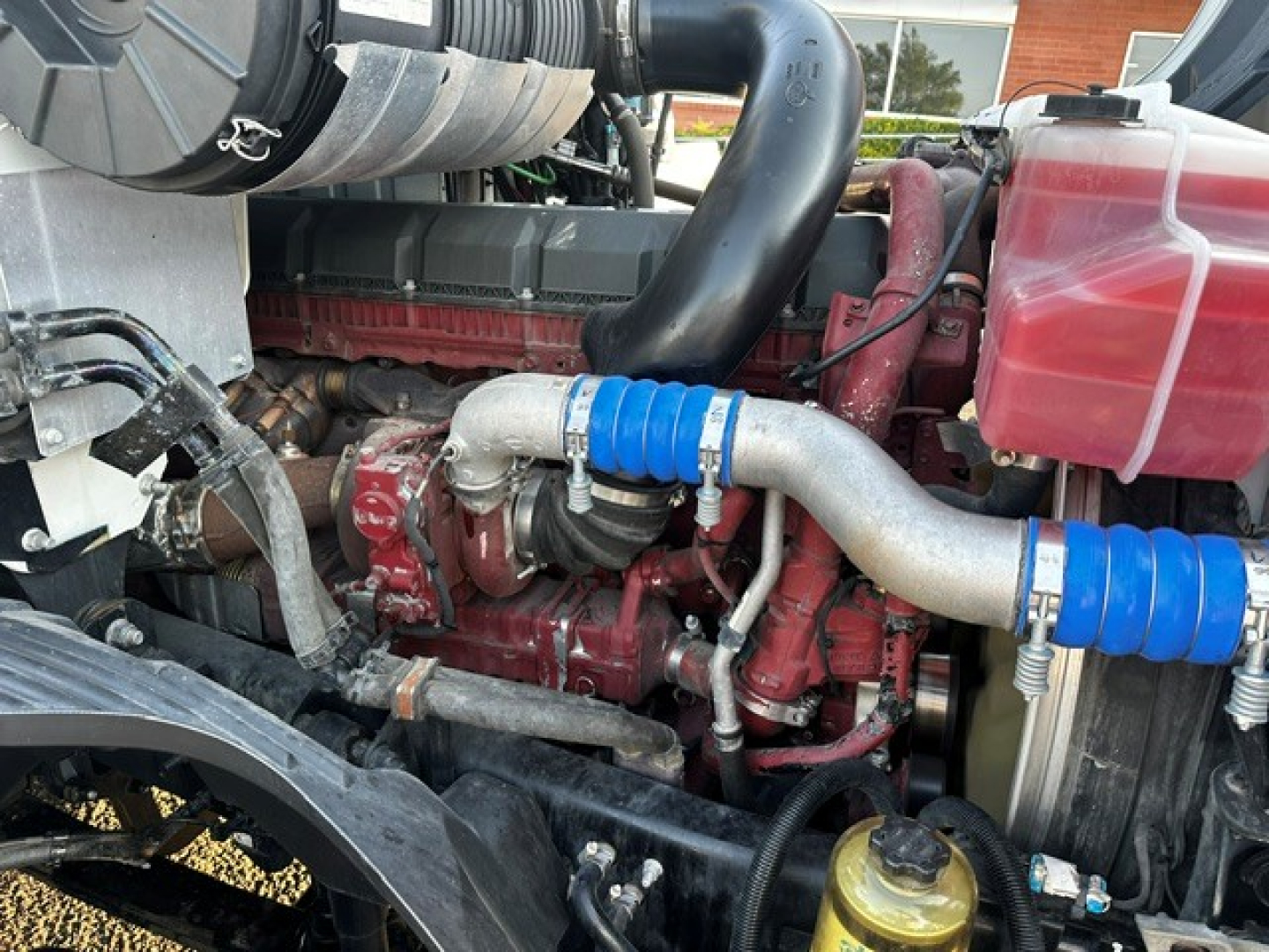 Mack ANTHEM engine bay showing turbocharger pipes with blue silicone couplers and coolant reservoir