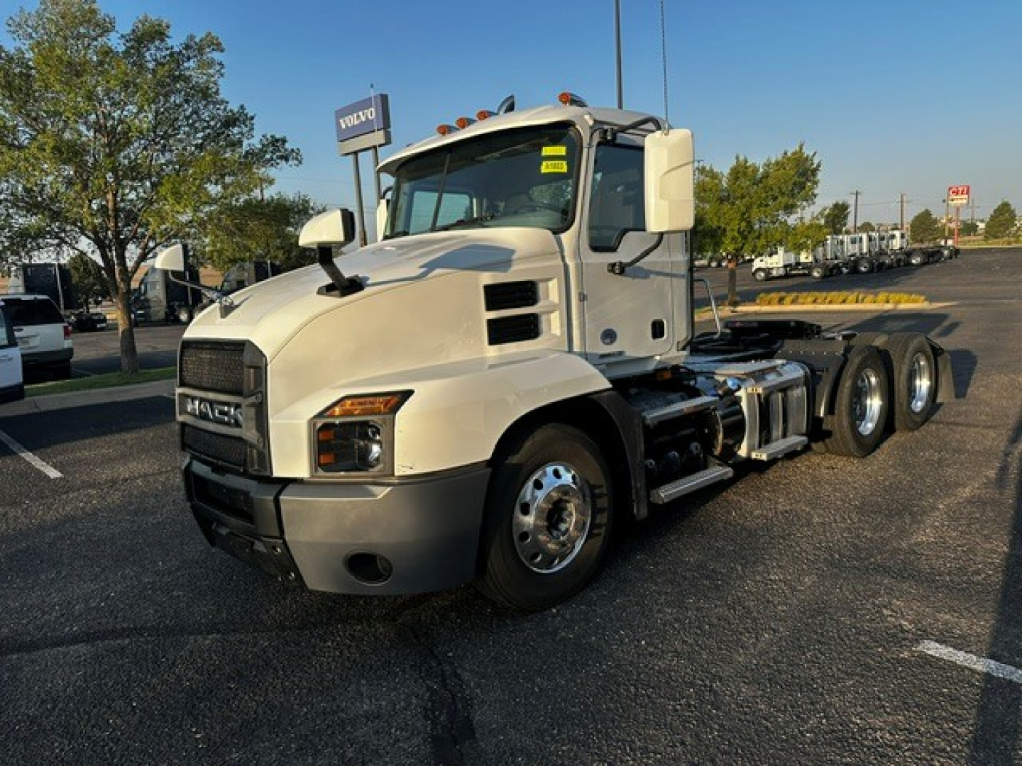 Truck chassis with a Mack ANTHEM cab in white, front grille visible, 6-wheel configuration, no trailer attached, side mirror, headlights, and large fuel tanks visible.