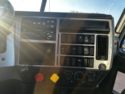 Dashboard panel of a 2021 Mack ANTHEM truck showing gear selector, climate controls, and auxiliary switches