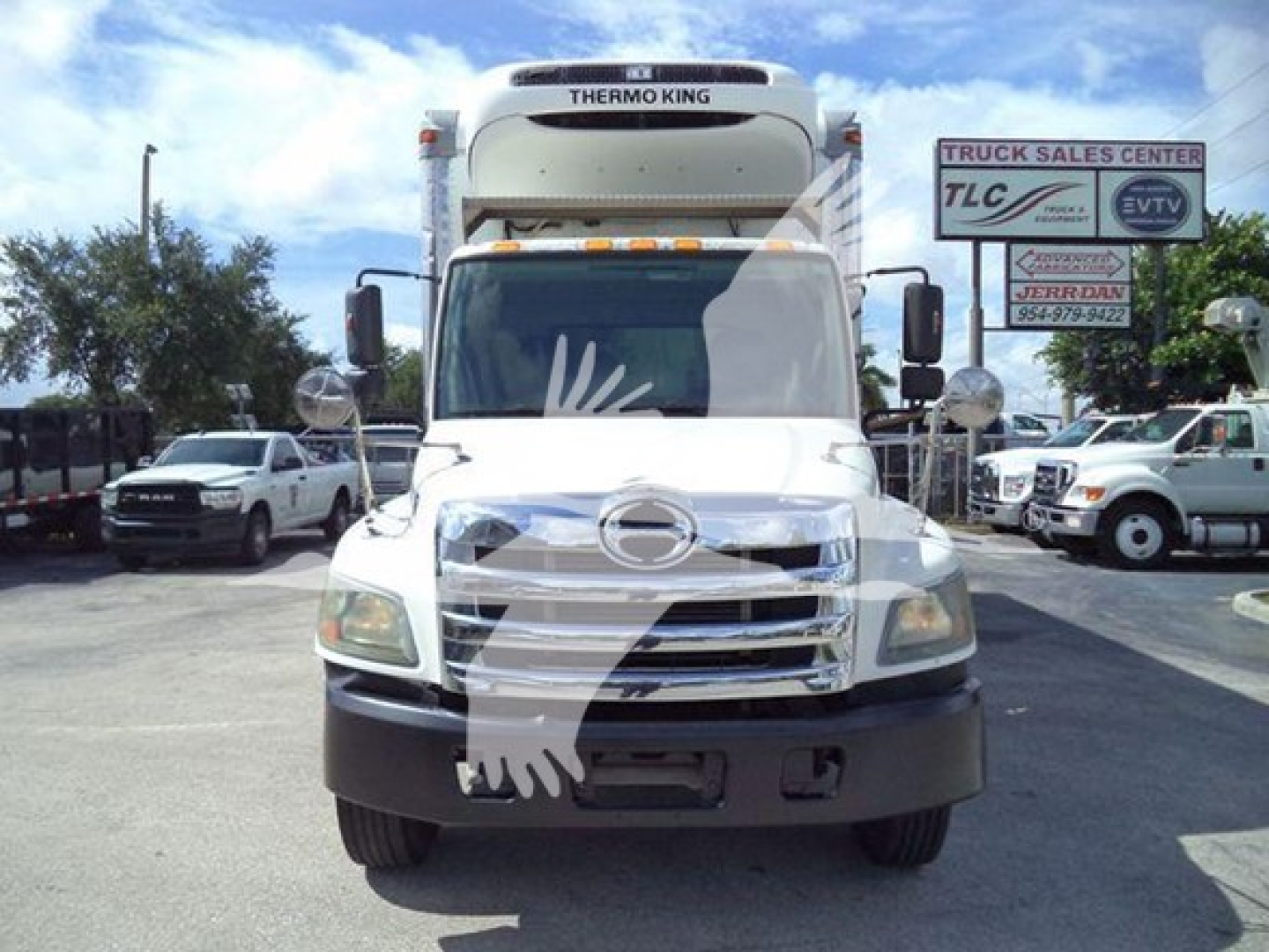 2015 Hino 268A refrigerated truck in a lot showing front view with Thermo King unit on cab top and large grille