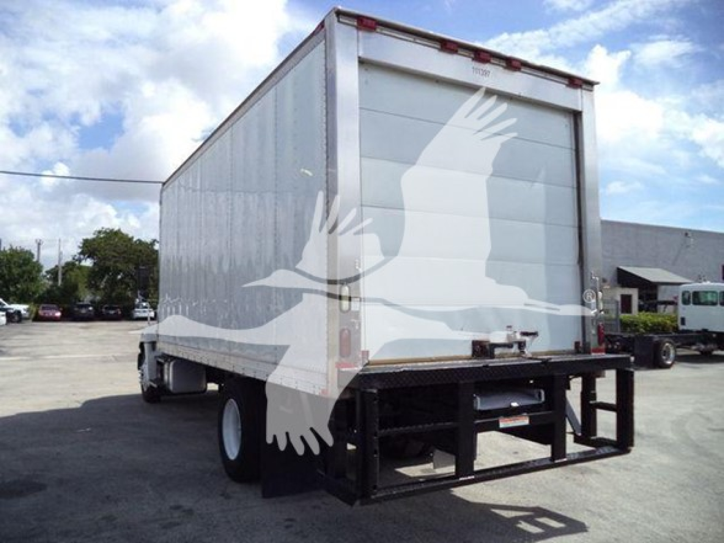 Used 2015 Hino 268A refrigerated truck rear/side view showing lift gate and box with blank light-gray doors.