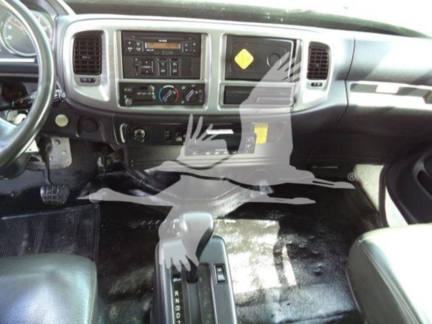 Interior cab of a 2015 Hino 268A refrigerated truck showing dashboard, steering wheel, center console with climate controls, gear shifter, and floor mats.