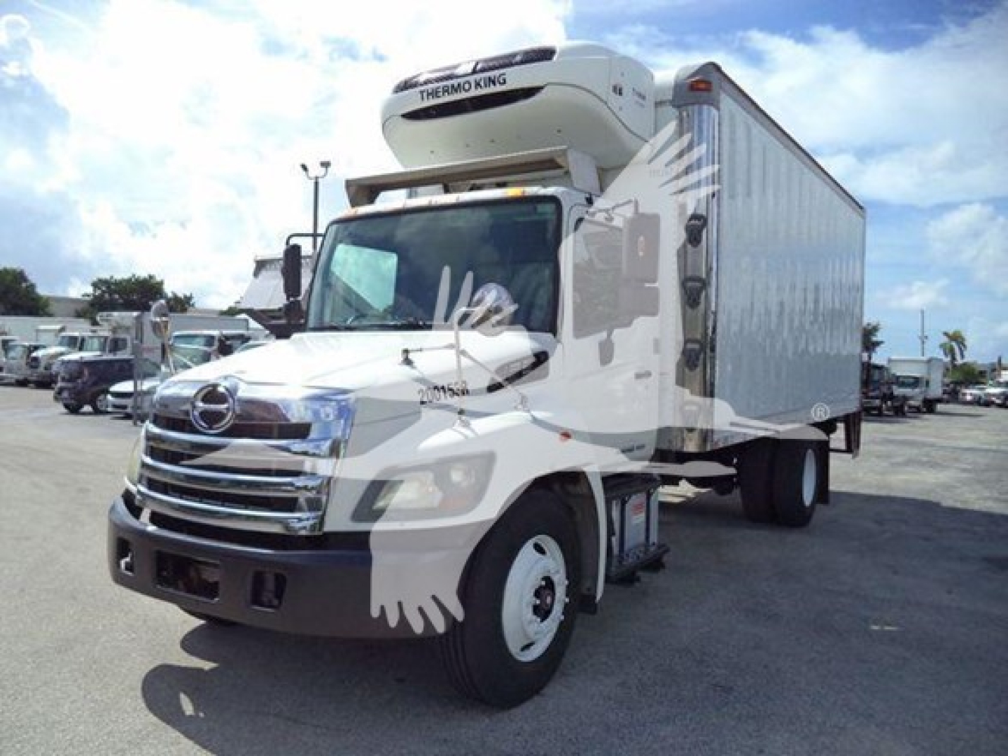 Hino 268A refrigerated truck with Thermo King unit on top, white cab and box, parked in lot.