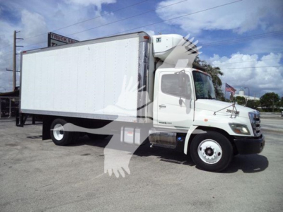 Hino 268A refrigerated box truck in profile view with white cab and box, VIN tag visible, stock number 200153R, yard setting.