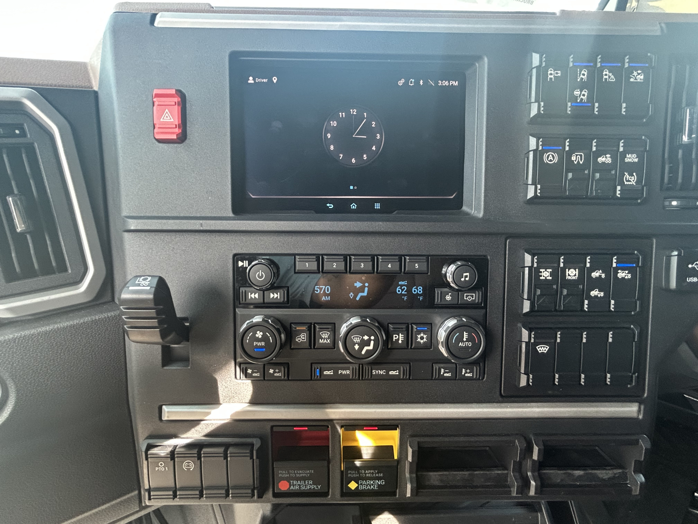 Dashboard of a 2027 Mack PR64T76H truck showing center console with climate controls, touchscreen/navigation display, and various switches; VIN and stock not visible.