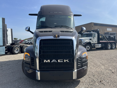 Mack PR64T76H conventional sleeper truck front view with large black grille and Mack logo, chrome bumper, headlights, and side mirrors.