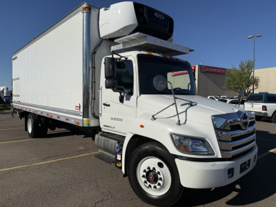 Truck with a refrigerated box, 2021 Hino 338, side view showing front grille, cab, and roof-mounted refrigeration unit.
