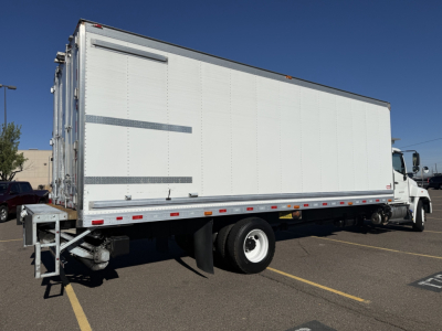 Side view of a white refrigerated box truck with empty service doors, showing the trailer and cab. No visible branding text.