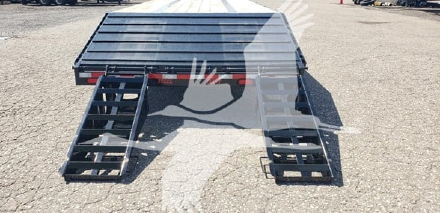 Beavertail dropdeck trailer viewed from rear with loading ramps extended.