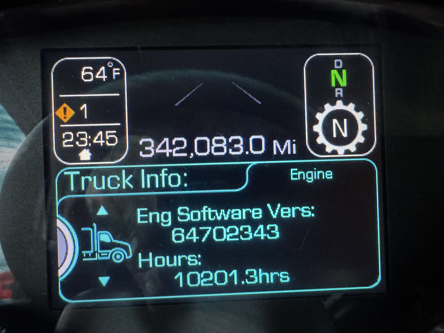 Kenworth T680 dashboard display showing mileage 342,083.0 miles, engine info, hours 10201.3, software version 647023343, transmission mode N, ambient 64°F.
