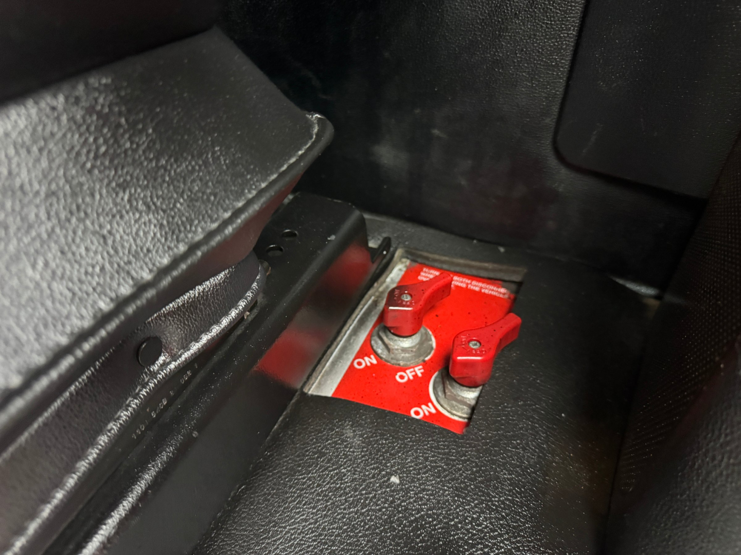 Kenworth T680 interior switch panel showing red ignition/switch lever and black surrounding trim.