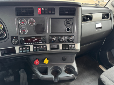 Dashboard of a Kenworth T680 cabin showing instrument cluster, climate controls, and auxiliary switches; visible text includes various gauges and control labels.