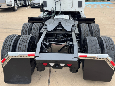 Kenworth T680 rear view showing chassis and dual rear axles with mud flaps and fifth wheel plate visible.