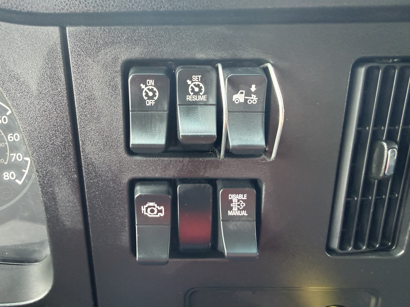 Dashboard switches and controls of a Kenworth T380 shown near the instrument cluster.