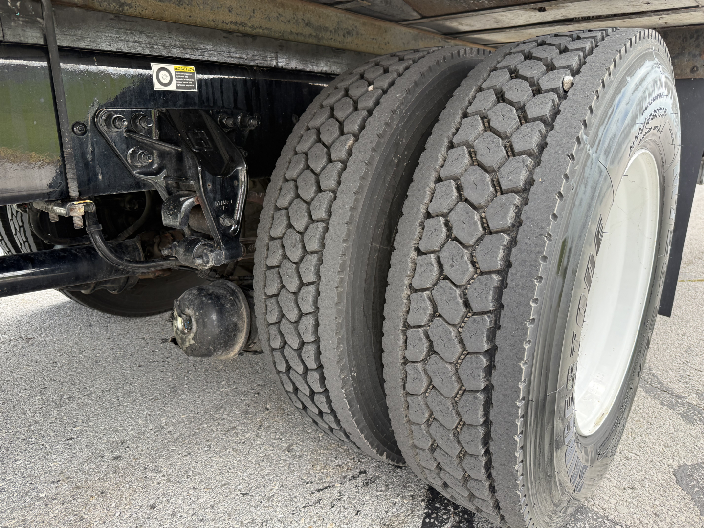 Kenworth T380 chassis and dual rear axles with heavy-duty tires in a refrigerated truck configuration.