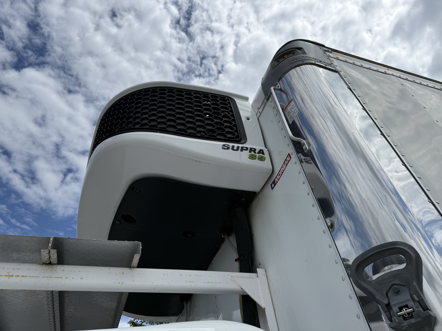 Kenworth T380 refrigerated truck radiator grille and cab front with Supra cooling unit visible.
