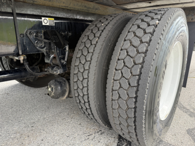 Kenworth T380 chassis and dual rear axles with heavy-duty tires in a refrigerated truck configuration.