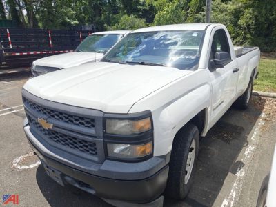 2014 Chevrolet Silverado 1500 pickup truck in a parking lot, white, crew cab with long bed. Front grille with Chevrolet bowtie emblem, black bumper, clear headlights, side mirrors.