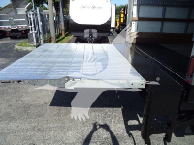 Hino 268A truck bed extension/platform with aluminum surface and attached storage unit on right. Visible text includes factory branding faintly on the aluminum platform edge.