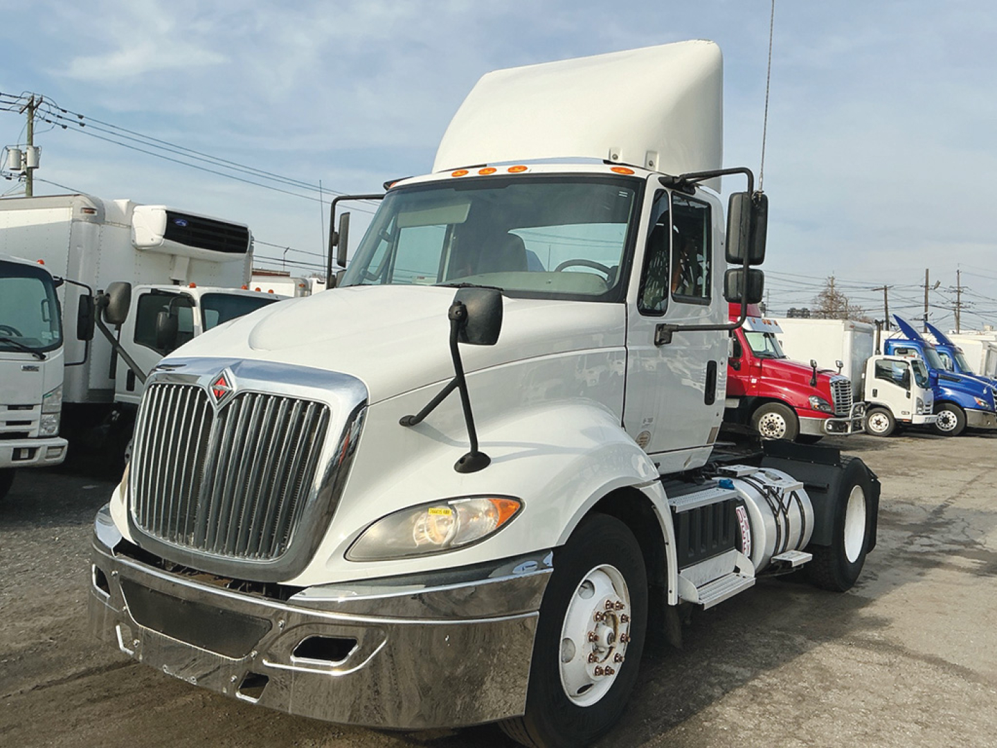 International ProStar+ 2018 conventional daycab truck in white showing front grille and cab details.