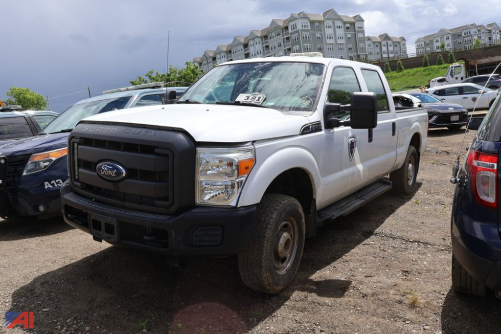 Ford F-250 Super Duty pickup truck in white, front-left view, parked in lot with other vehicles.