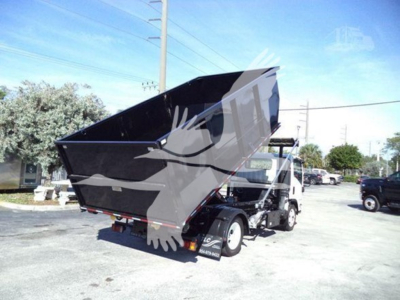 Isuzu NRR roll-off truck showing dump bed raised with rear view and logo watermark overlay