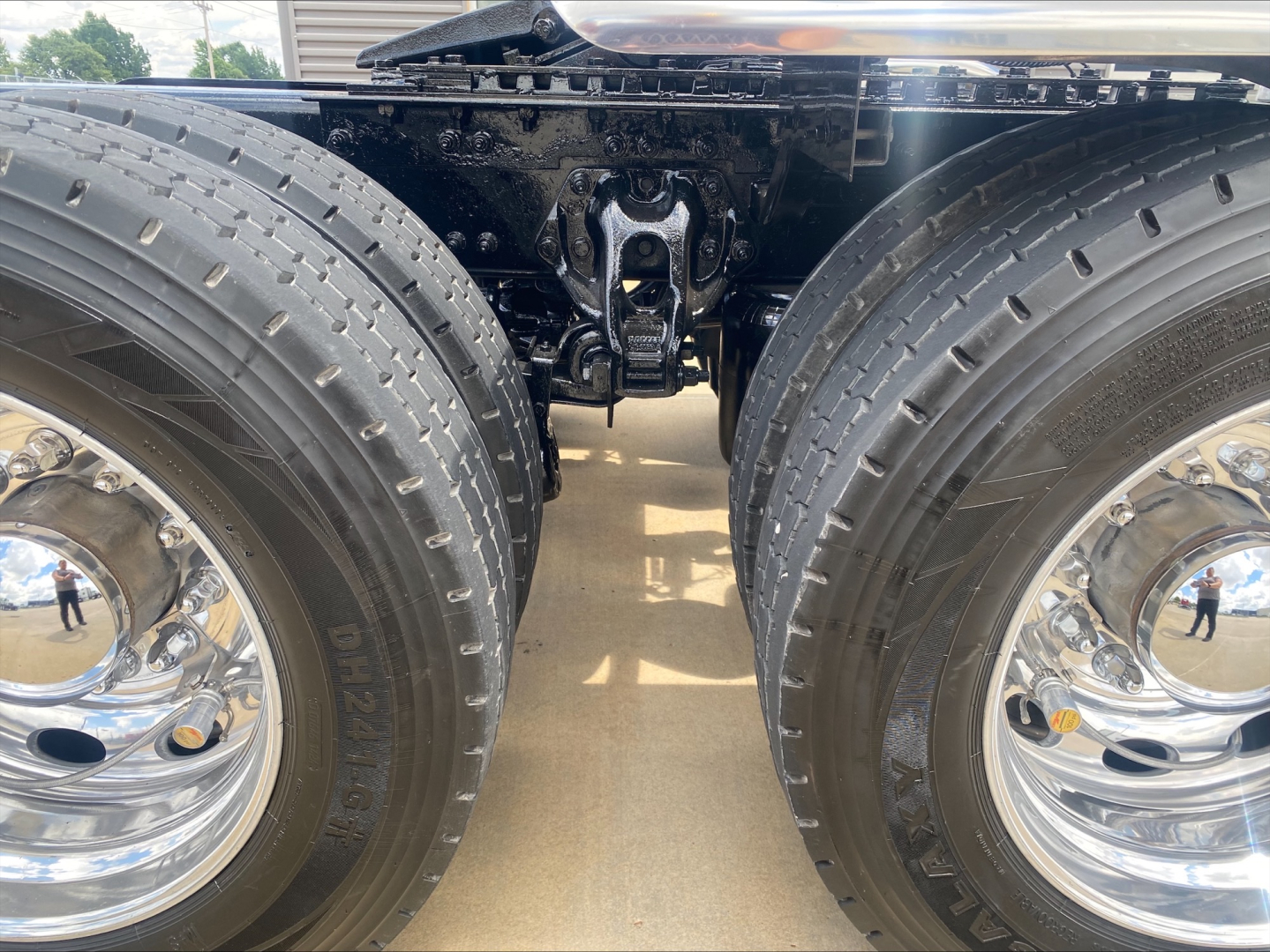 Peterbilt 389 truck rear dual wheels chassis and fifth wheel area showing tires and polished rims.