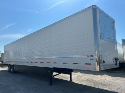 Trailer side and rear view showing a 2027 Utility reefer trailer with metal corrugated sides, rear doors, and landing gear visible.
