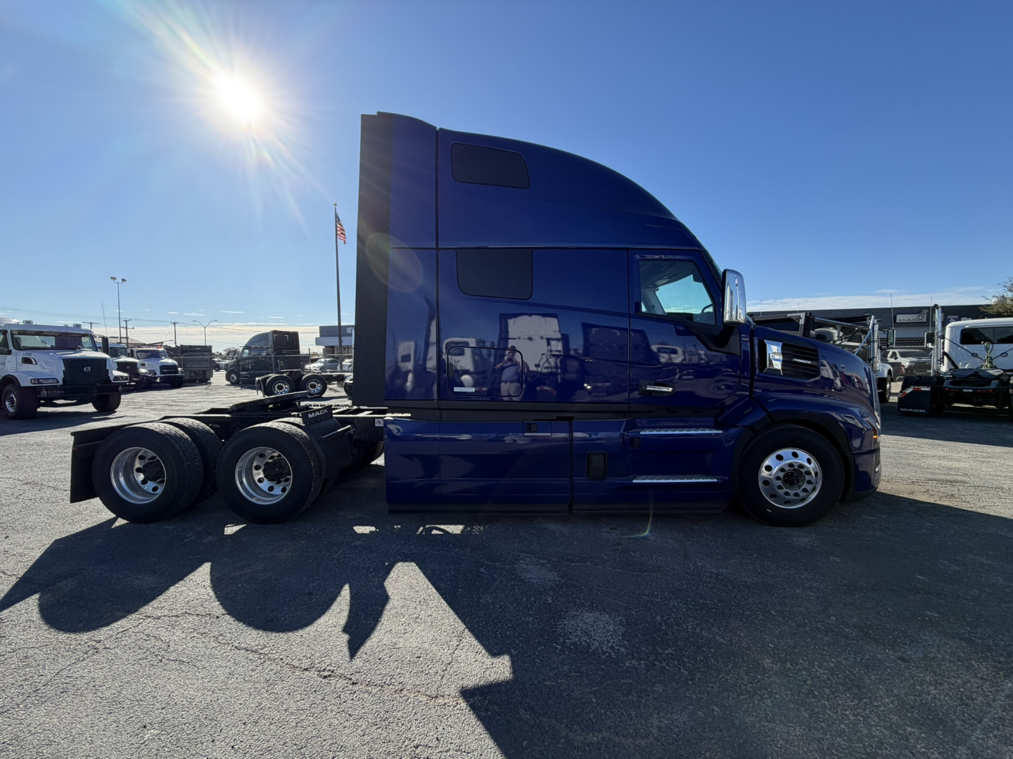 Mack PR64T76H conventional sleeper truck side view showing blue cab and chassis with 6x4 wheel configuration.