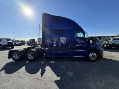 Mack PR64T76H conventional sleeper truck side view showing blue cab and chassis with 6x4 wheel configuration.