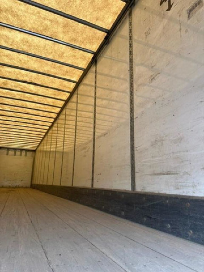 Interior of a Wabash van trailer showing empty cargo space with side walls and roof ribs.
