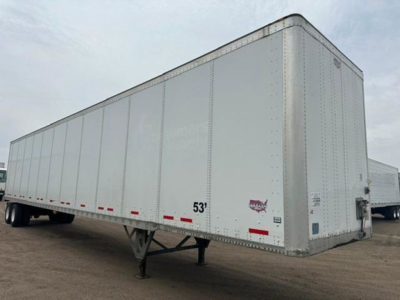A 53' white trailers box van with wheel-less front, trailer landing gear, and reflective red/white markings.