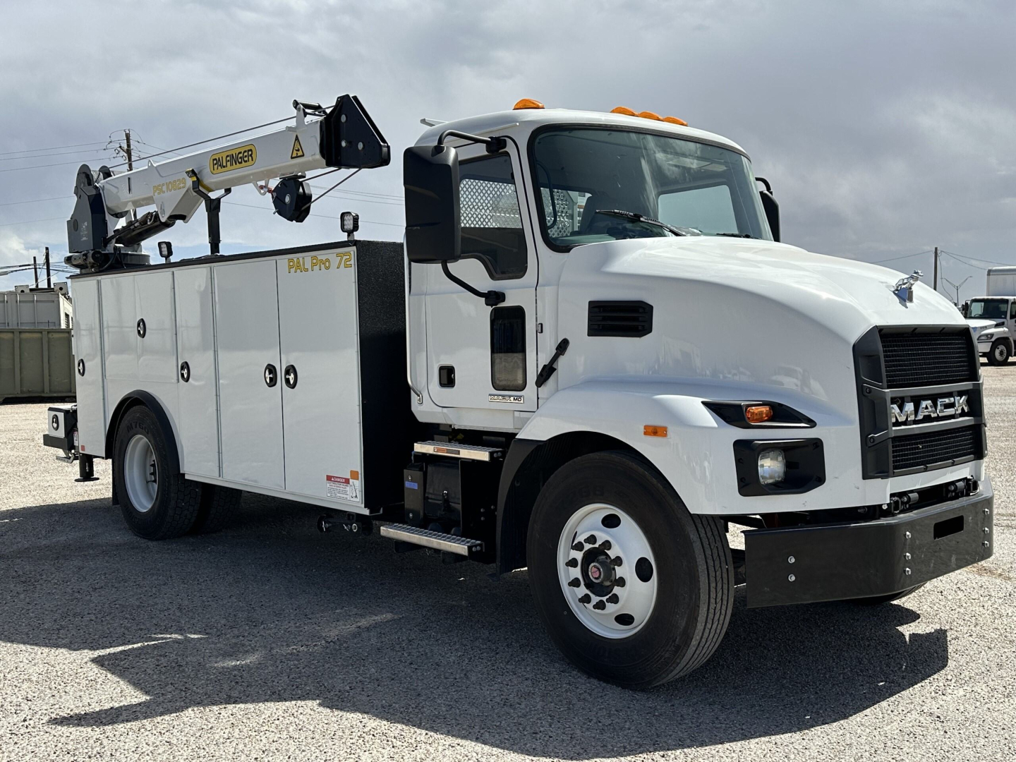 Mack MD7 service truck with crane arm on side, white cab and utility body, VIN 1M2MDBAA4SS076106 visible, stock 65650, new unit.