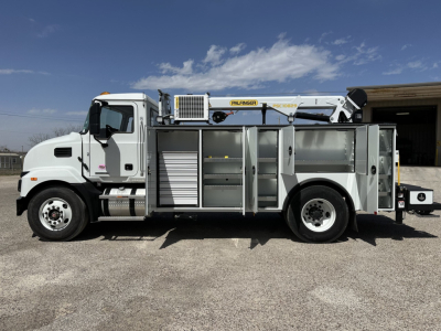 Service/Utility truck side view showing ladder rack and storage compartments on a 2025 Mack MD7 with Aerials and tool box.