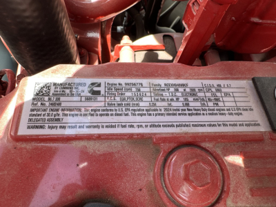 Mack MD7 engine data plate showing model number, engine serial, fuel rate and EPA information. Visible text includes 'MANUFACTURED BY ... ENGINE NO. 9256679' and other specifications, on a metallic engine tag.