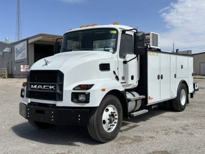 Mack MD7 service utility truck in white front-left view showing cab and utility compartments with stock number 65650 and VIN plate visible.