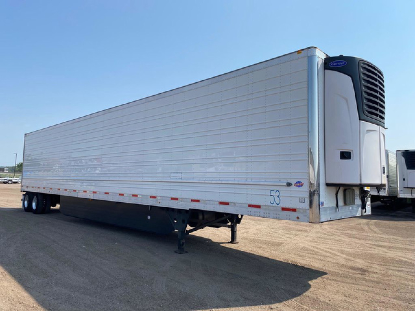 Utility reefer trailer showing side view with reefer unit at front, aluminum body, and landing gear visible.