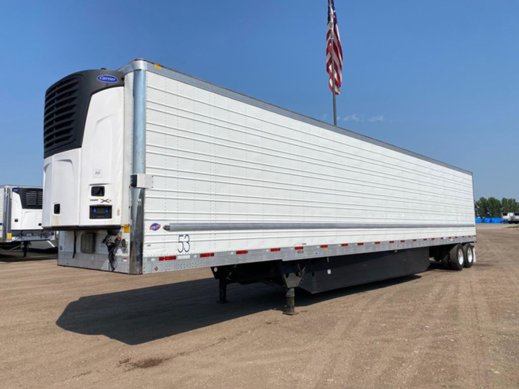 Utility reefer trailer with a Thermo King refrigeration unit at the front showing a white aluminum side and landing gear undercarriage.
