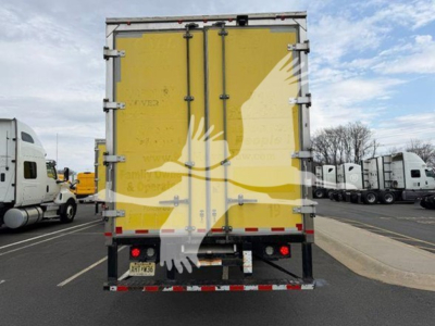 Rear view of a 2020 International MV moving van with yellow cargo doors and reflective rear bumper.