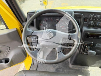 Dashboard and steering wheel view inside a yellow 2020 International MV moving van showing steering wheel and instrument cluster