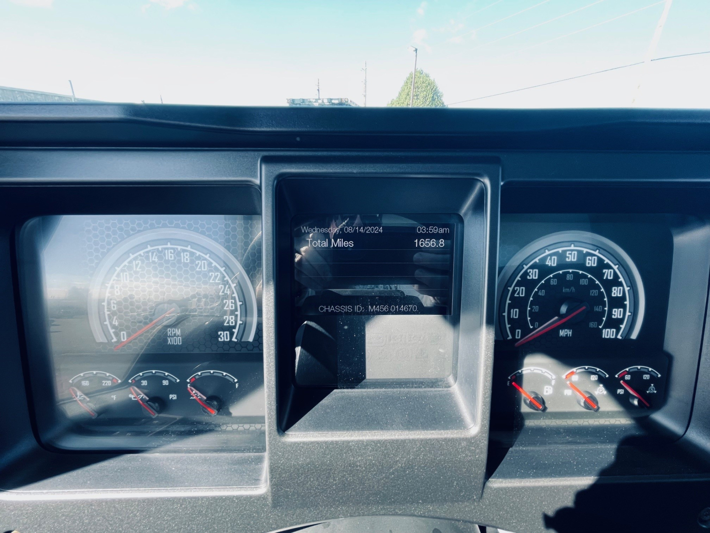 Dashboard of a 2026 Mack MD6 showing instrument clusters and center display with mileage and total miles readout.