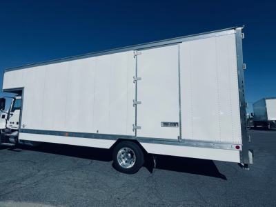 Box truck side view showing cargo box and wheel with a small door, no visible text legible on the box.