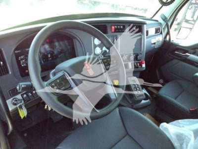 Kenworth T880 cab interior showing steering wheel, instrument cluster, and dashboard controls.