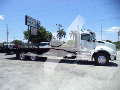 Kenworth T880 rollback truck with flatbed, side view showing cab and wheel layout